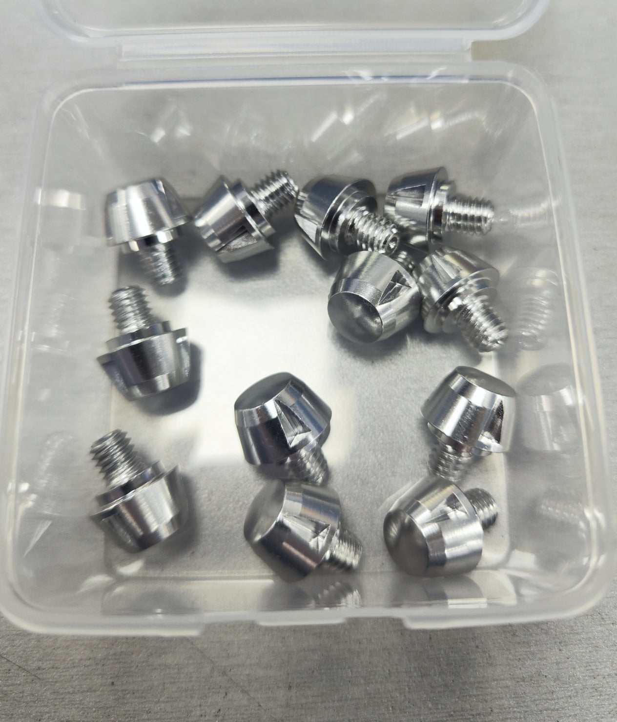 Lightweight aluminum replacement studs with key in a clear box, available in silver, gun metal, and black, compatible with boots 
