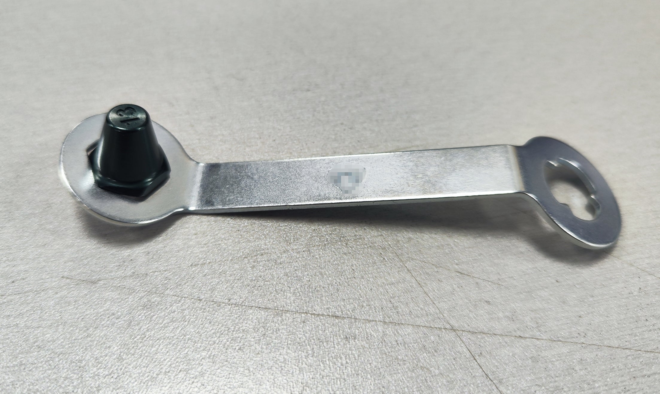 Lightweight aluminum replacement studs with stud key on a table.