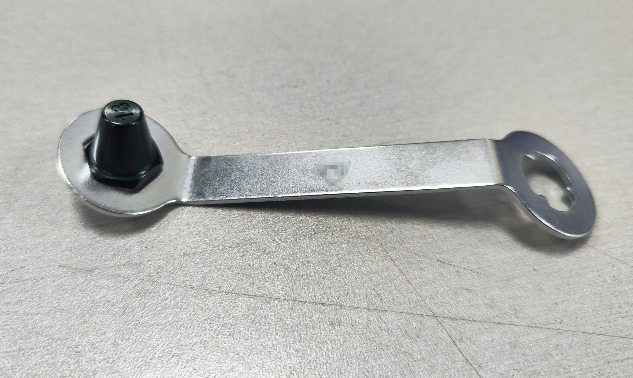 Lightweight aluminum replacement studs with stud key on a table.